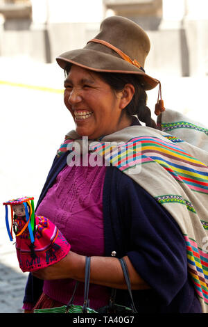 peruvian lady selling dolls Stock Photo