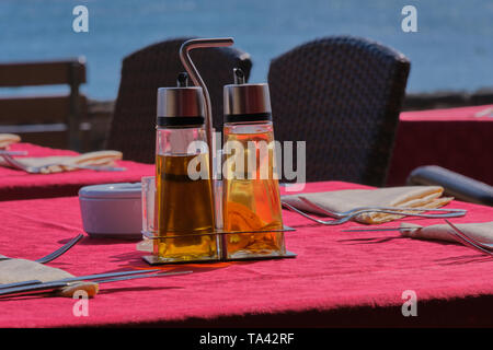 laid table with vinegar and olive oil at the promenade in Playa Blanca, Lanzarote, in the background is blurred the Atlantic Stock Photo