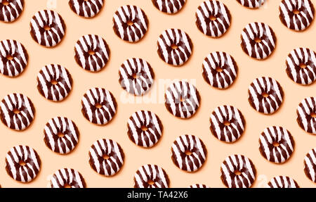 Chocolate donuts pattern on orange background Stock Photo