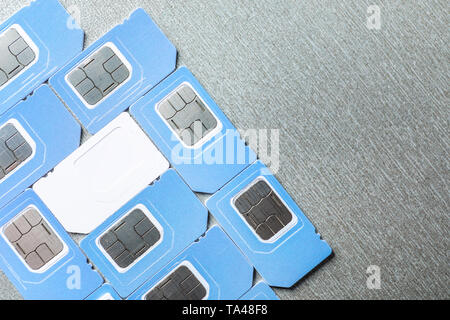 Many sim cards on grey background Stock Photo