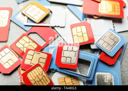 Many sim cards on grey background, closeup Stock Photo