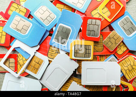 Many sim cards on grey background, closeup Stock Photo