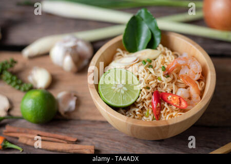 Close-up shot Instant noodles with lemon shrimp chilli hot and spicy on old wooden table select focus shallow depth of field Stock Photo
