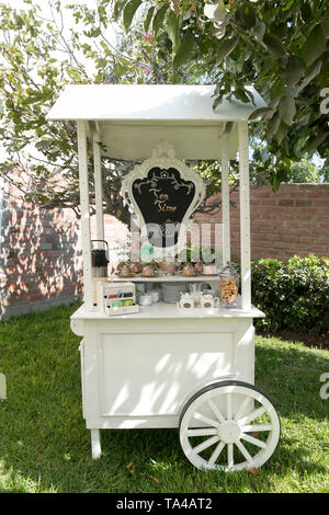 Small and cozy cart for coffee and tea. With a slate. Wedding Stock Photo