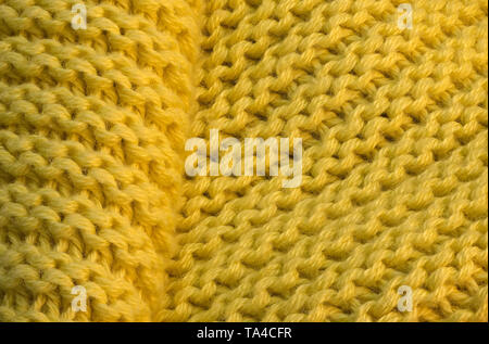 Artistic background from yellow knitted wool fabric with large loops macro photography Stock Photo