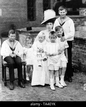 The picture was taken at Schloss Gelbsand, the hunting lodge of the Dukes of Mecklenburg. The Prussian princes are pictured here with their grandmother Anastasia von Mecklenburg and her cousins. From left to right: Prince Knut of Denmark, Prince Hubertus of Prussia, Duke Frederick Francis of Mecklenburg-Schwerin on the lap of Grand Duchess Anastasia of Mecklenburg-Schwerin (nee Anastasia Mikhailovna Romanova), Prince Louis Ferdinand of Prussia, Prince William of Prussia, Prince Frederick of Denmark. Stock Photo