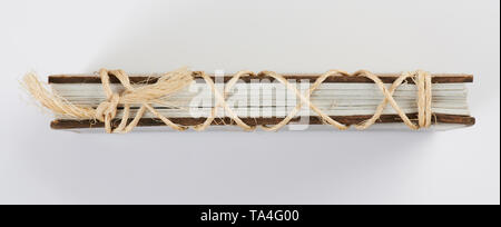 Side view of book with rope isolated on white background Stock Photo