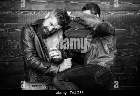 Physical attack. Men bearded hipster fighting. Attack and defence. Aggressive hooligan fighting with strong bully man. Street fight concept. Men brutal hooligans wear leather jackets fighting. Stock Photo