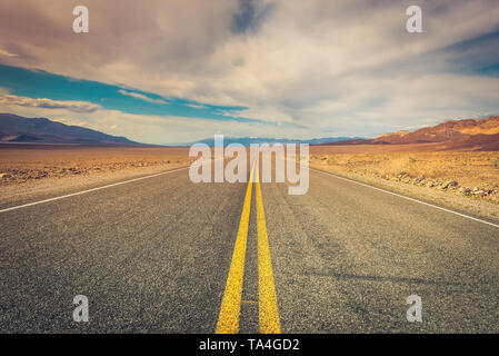 A lonely desolate road in Death Valley National Park, California, USA. Stock Photo