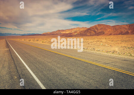 A lonely desolate road in Death Valley National Park, California, USA. Stock Photo