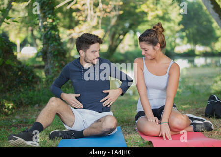 Man explaining to woman during fitness workout Stock Photo