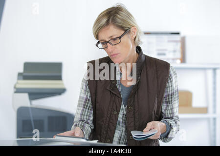 mature repairer fixing printer Stock Photo