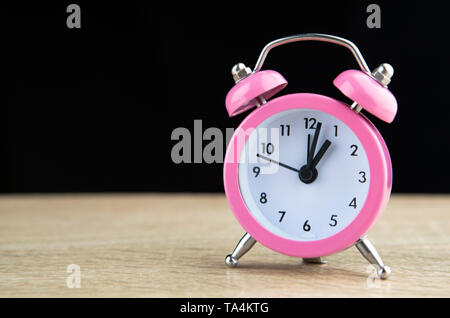 Retro alarm clock on a black background Stock Photo