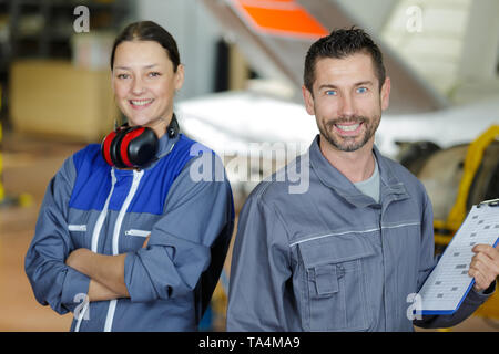 engineer man and woman looking at the camera Stock Photo