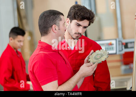 modern factory worker with teacher in workshop Stock Photo