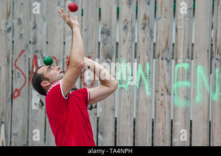 man performing street juggling in Quimper, Brittany, France Stock Photo