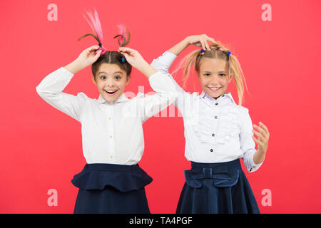 Meet new friends in school. School friendship. Should school be more fun. Schoolgirls with cute hairstyle and happy smiles. Best friends excellent pupils. Schoolgirls tidy appearance glad to meet you. Stock Photo