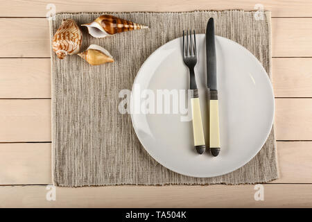 Simple table setting with marine decor on wooden background Stock Photo