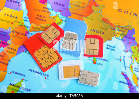 Many sim cards on world map Stock Photo