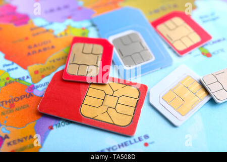 Many sim cards on world map Stock Photo