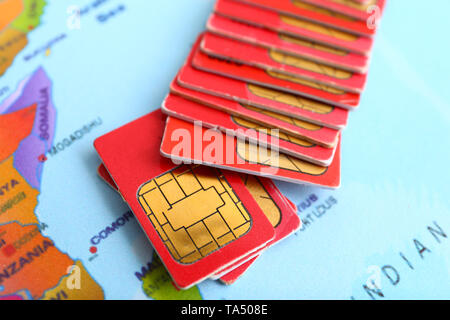 Many sim cards on world map Stock Photo