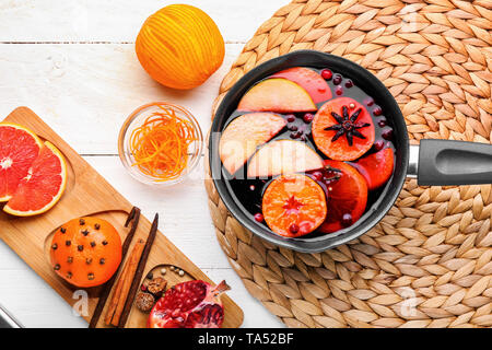 Composition with tasty mulled wine and ingredients on white wooden background Stock Photo