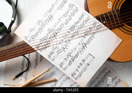 Composition with guitar and music sheets on white background Stock Photo