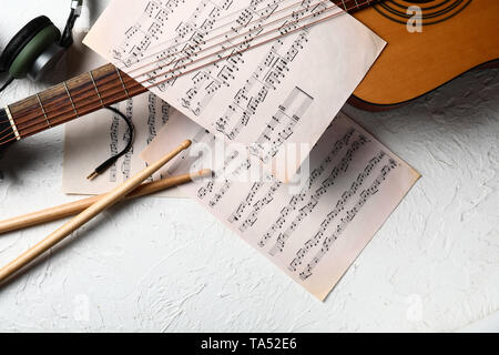 Composition with guitar and music sheets on white background Stock Photo