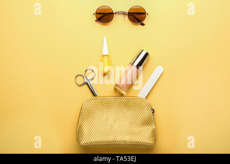 Stylish sunglasses with female items on color background Stock Photo
