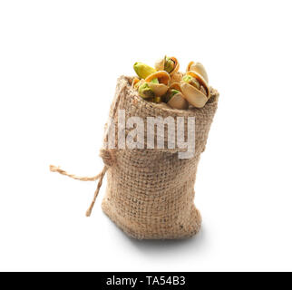 Bag with tasty pistachio nuts on white background Stock Photo