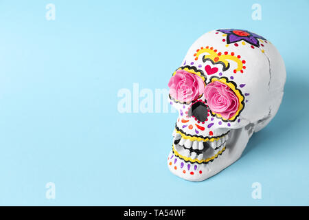 Painted human skull for Mexico's Day of the Dead on color background Stock Photo