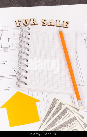 Inscription for sale, notepad for notes and money on electrical diagrams, selling and buying house or flat concept Stock Photo