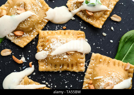 Tasty ravioli on slate plate Stock Photo