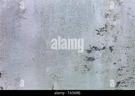 Beautiful texture of the pattern of grind gray concrete with black impregnations on the wall Stock Photo