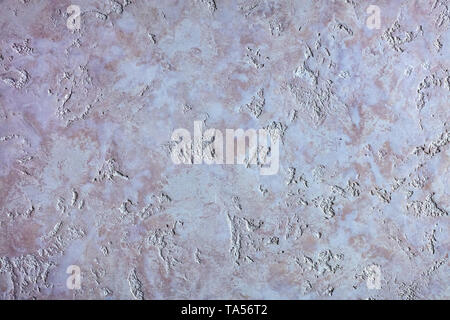 Beautiful texture of a picture of Venetian plaster, similar to the purple air granite on the wall Stock Photo