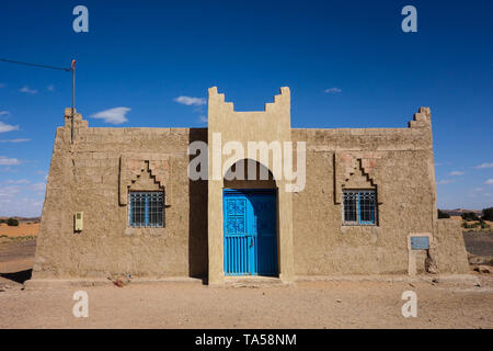 House with blue door in a small village in the Sahara desert near Merzouga, Morocco Stock Photo