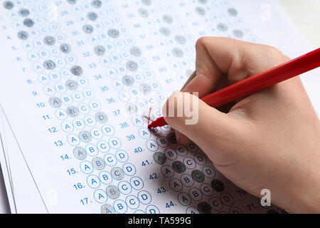 Teacher checking answer sheet after exam, closeup Stock Photo - Alamy