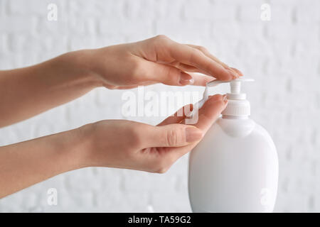 Woman washing hands with liquid soap on white background Stock Photo