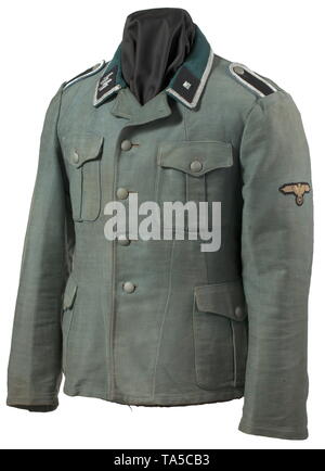 A field tunic M 36 of an SS-Unterscharführer in a transport or supply unit private purchase piece Summer issue made of dark field-grey moleskin with metal buttons and dark-green collar, with RZM belt hooks sewn into the side seams on the back, the sleeve ends in the style of the depot pieces, partially lined with brown cotton cloth. Silver braiding signifying the rank of Unterführer, black collar patches with runes and metal rank stars respectively, all embroidered in silver, sewn-on black shoulder boards with light-blue branch colour, machine-embroidered sleeve eagle on bl, Editorial-Use-Only Stock Photo