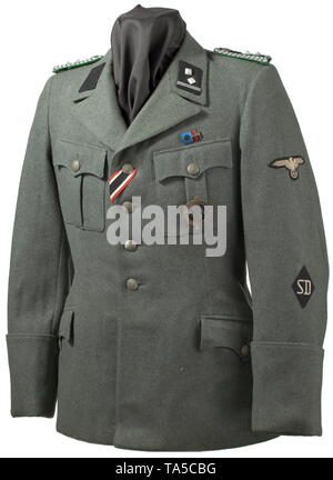 A field tunic M 38 for an SD-Hauptscharführer depot piece from the duty station in Prague Cut in the style of the black tunic, made of field-grey woollen cloth with metal buttons, brown lining with bandage pack pocket and depot stamp 'G.St. Prag'. Black collar patches without piping (from 1942 onwards), slip-on shoulder-boards with police pattern but with black interweaves and middle section. Sleeve eagle and SD sleeve diamond in light-coloured RZM embroidery on black ground. War Merit Cross ribbon, field orders clasp with SS Long Service Award and pinned-on SA Sports Badge, Editorial-Use-Only Stock Photo