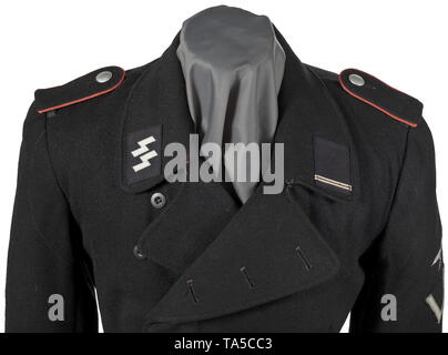 A field tunic of the black special uniform for an SS-Sturmmann in the SS armoured units depot piece SS cut with straight button fly and one-piece back made of black woollen cloth with synthetic resin buttons. Lining of black imitation silk with sleeve trims made of Italian herringbone-patterned fabric. The loops for the belt hooks and the adjustment bands have been removed. Frequently worn, with repairs. Black collar patches in BeVo weave, the right one with runes woven in silver-grey. Black slip-on shoulder boards with pink piping. Sleeve eagle in silver-grey BeVo weave on, Editorial-Use-Only Stock Photo