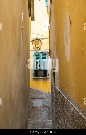 Riomaggiore, Italy - April 21, 2019 Colorful stairs alley in Riomaggiore Cinque Terre Region in Italy