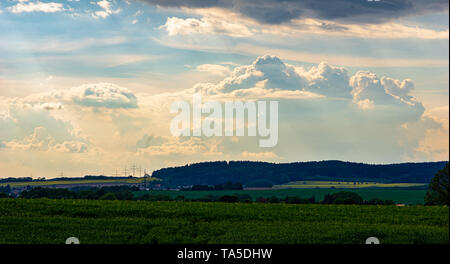 dramatic sky with sunrays breaking through storm clouds Stock Photo