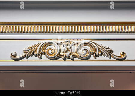 Luxury interior. Stucco elements on light wall. White patterned. Mouldings element from gypsum. Roccoco style Stock Photo