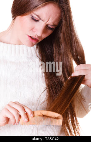 Dissatisfied woman combing with brush and pulls at her long hair. Being  unhappy for nice look in daily activity Stock Photo - Alamy