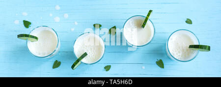 Ayran, homemade yogurt drink (kefir, lassi) with cucumbers - healthy summer refreshing cold drink, banner. Stock Photo