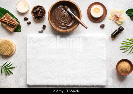 Chocolate Spa flat lay on white background, top view, copy space. Natural spa beauty products with chocolate and plants. Stock Photo