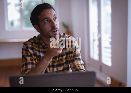Man executive talking on mobile phone in the office Stock Photo