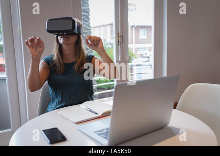 Women using virtual reality headset at a table Stock Photo