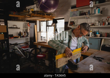Mature carpenter working in workshop Stock Photo